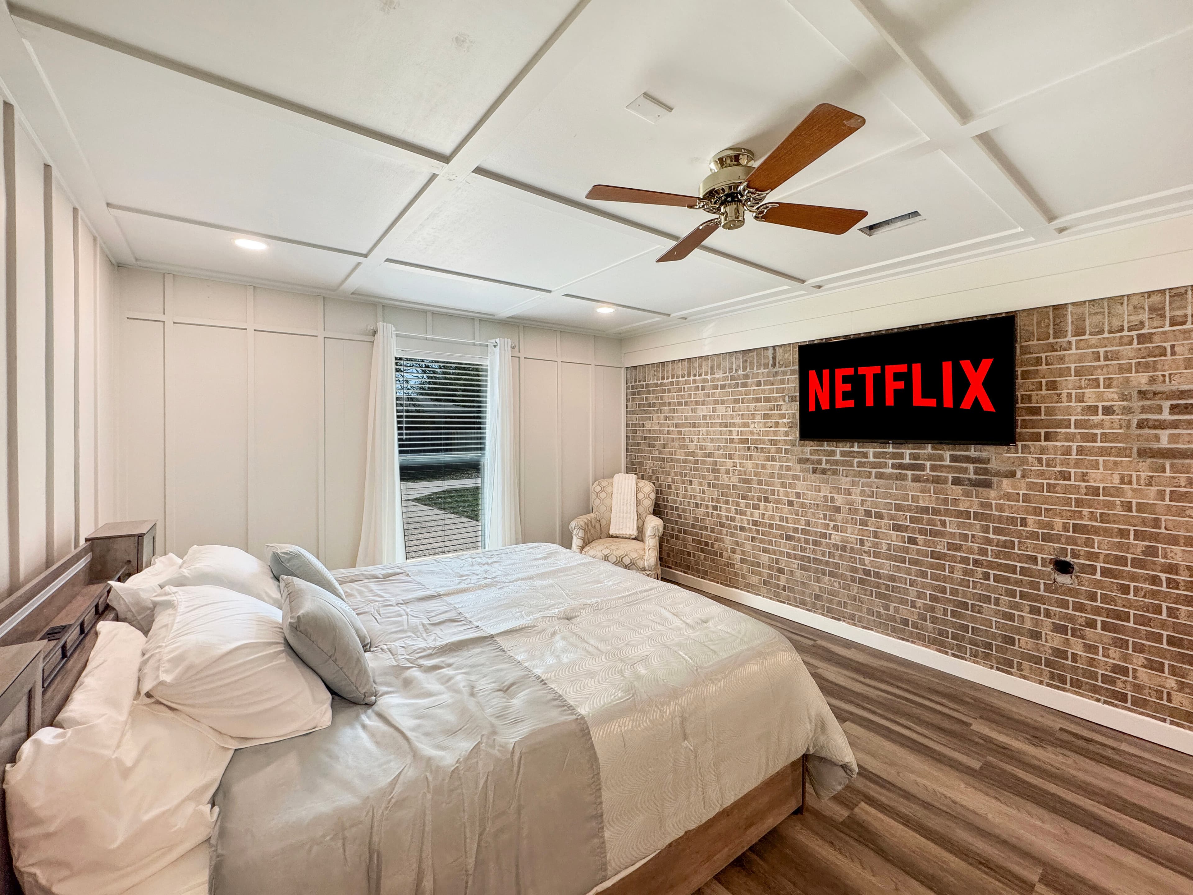 Bedroom with brick accent wall