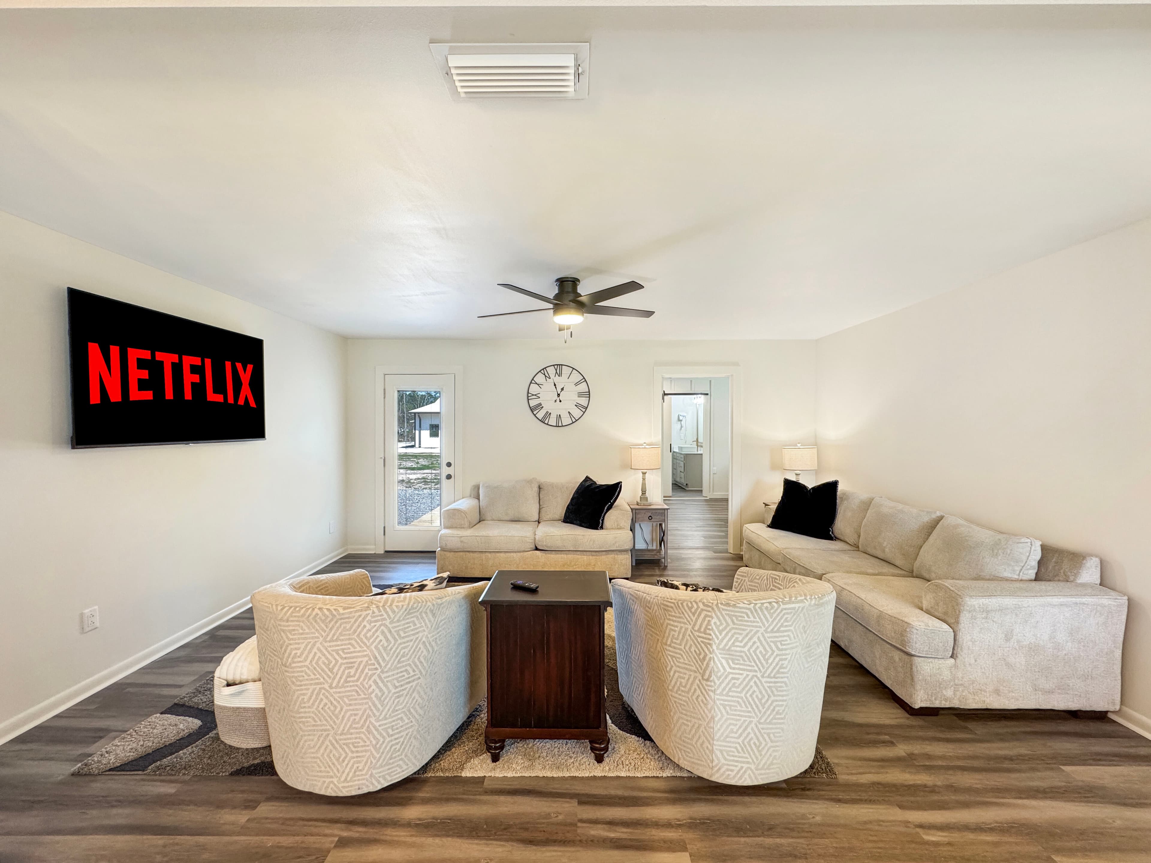 Open living and entertainment space with seating and TV